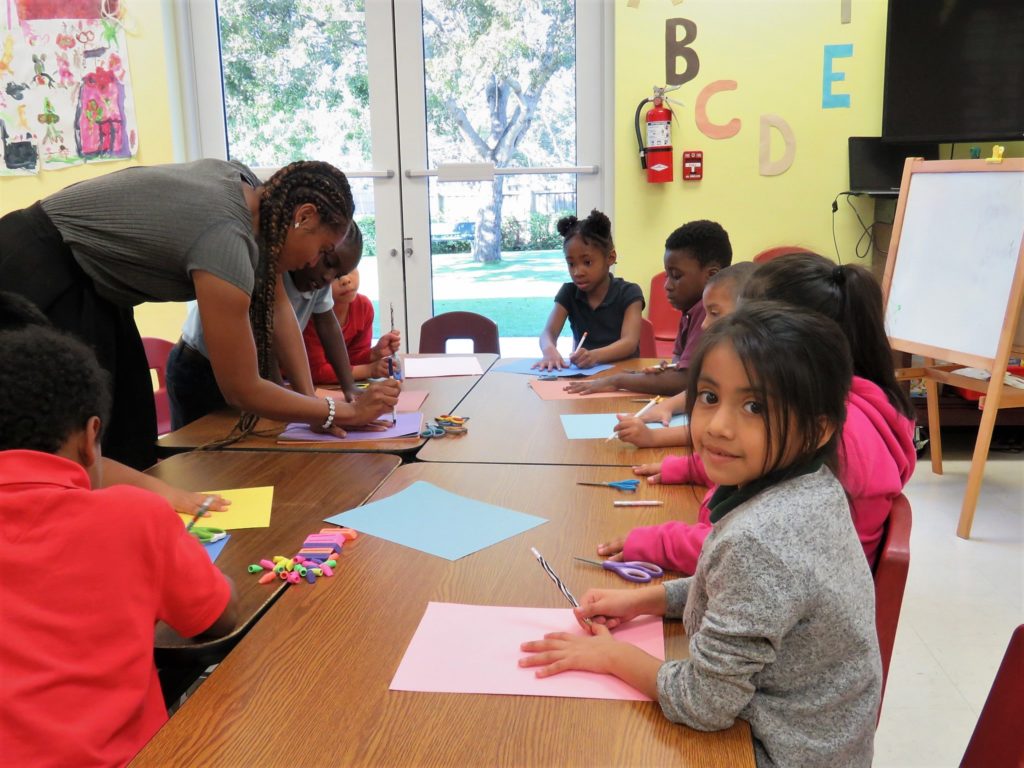 Teacher assisting Project Grow students in a classroom