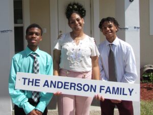 The Anderson Family posing in front of their home