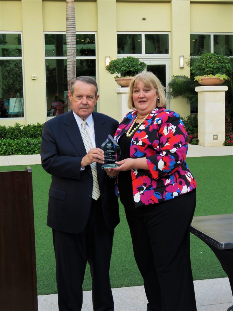 Former Board Chair Bill Peterson and Heather Ferguson with The Crystal Castor Award for Outstanding Volunteer Service