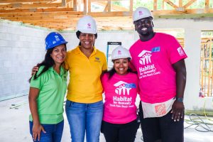 Service Enriched Housing clients Jerrod and Iesha James posing at their Habitat for Humanity home construction site.