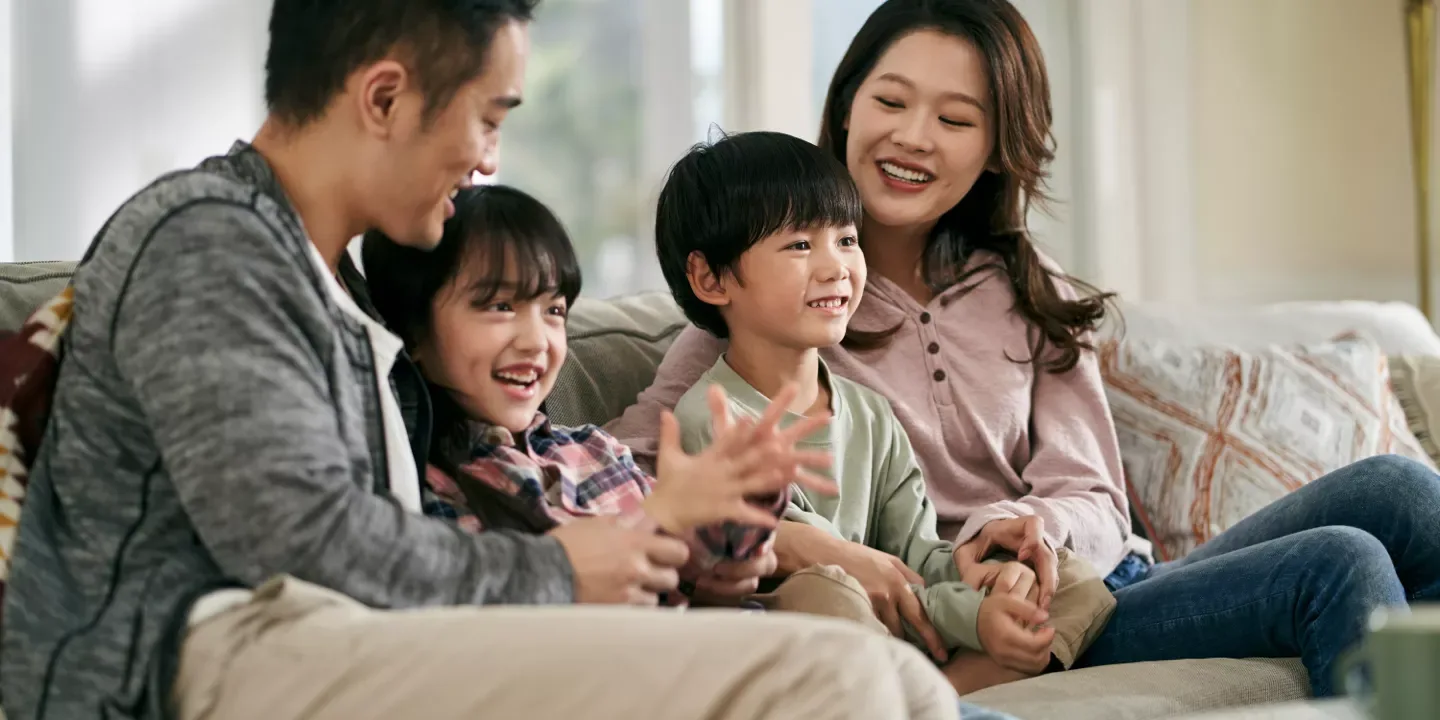 couple with kids on couch