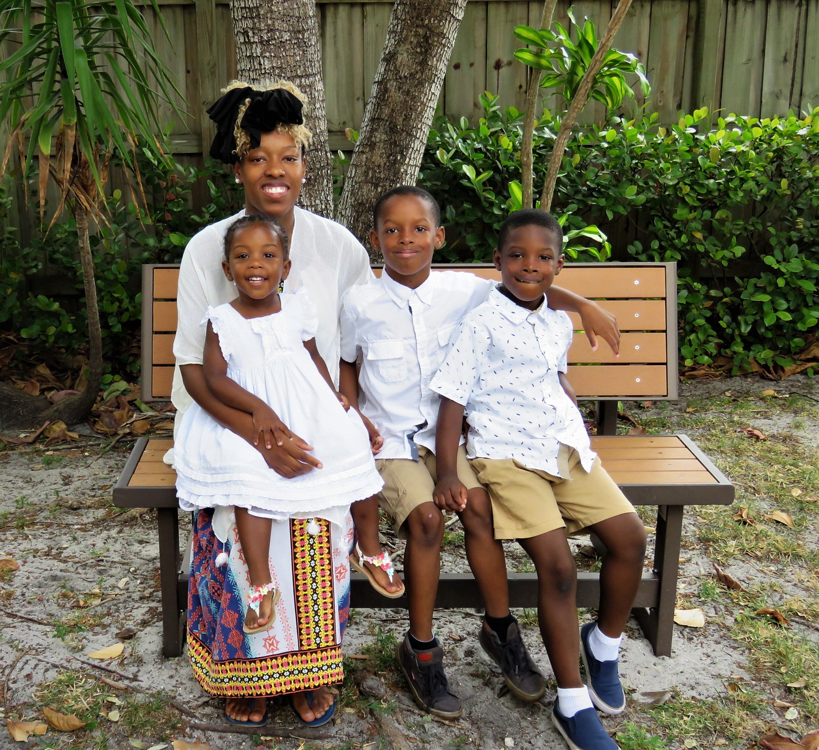 Client and her three kids sitting on a bench