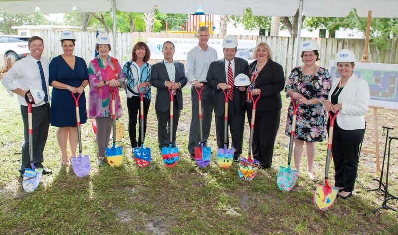 Adopt-A-Family CEO, board members and donors with shovels at the site of Third Avenue Homes