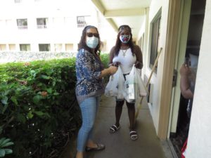 AAF staff member visits client to deliver groceries during COVID-19 pandemic.
